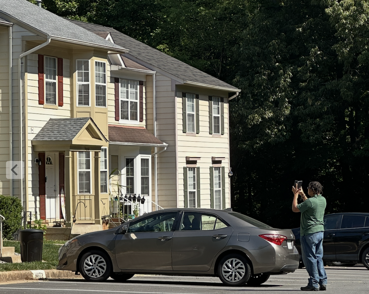 Property inspector documenting exterior maintenance conditions in a townhouse community